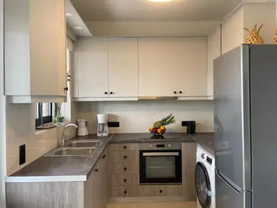 a kitchen with white cabinets and a sink and a dishwasher at Mossa City Apartments - 2 km from Old Town - Private parking in Chania Town