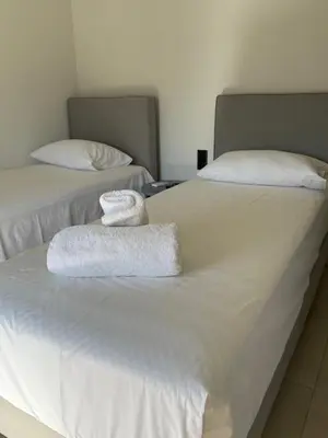 two beds with towels sitting on top of them at Mossa City Apartments - 2 km from Old Town - Private parking in Chania Town