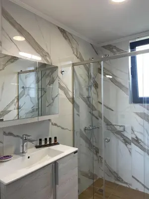 a bathroom with a sink and a shower at Mossa City Apartments - 2 km from Old Town - Private parking in Chania Town