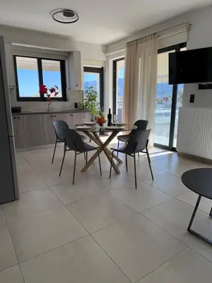 a kitchen and dining room with a table and chairs at Mossa City Apartments - 2 km from Old Town - Private parking in Chania Town