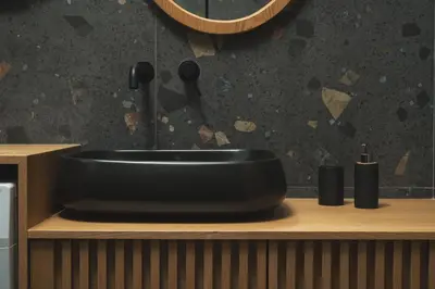 a black sink sitting on a counter in a bathroom at Limani elegant apartments in Souda