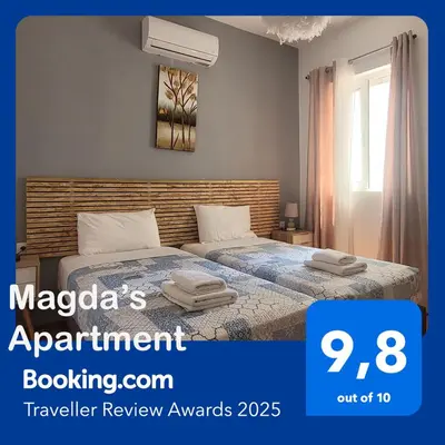 a bedroom with a bed and a window at 3 bedroom apt in Nea Chora 400 meters walk to the beach in Chania Town