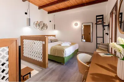 a bedroom with a bed and a desk and a table at Casa Nicola's in Chania Town