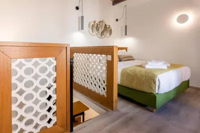 a bedroom with a bed with a wooden frame at Casa Nicola's in Chania Town