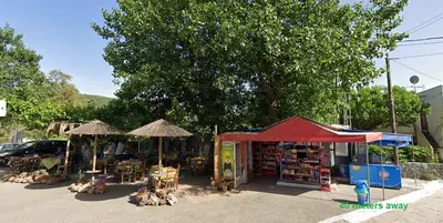 a book store with umbrellas and books in a street at Luxury Dream with Private Jacuzzi in Kaloudhianá