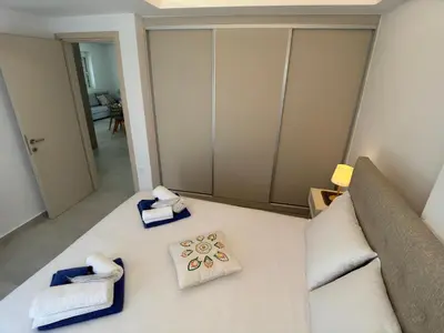 a bedroom with a bed with towels on it at Luxury Dream with Private Jacuzzi in Kaloudhianá