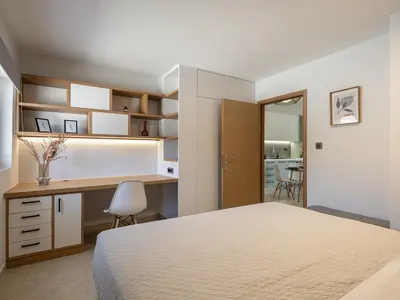 a bedroom with a bed and a desk at Elysian Sea-View Chania in Stérnai