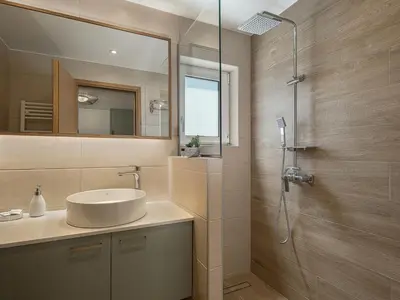 a bathroom with a sink and a shower at Elysian Sea-View Chania in Stérnai