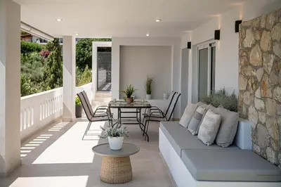 a living room with a couch and a table at Elysian Sea-View Chania in Stérnai