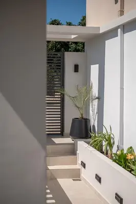 a hallway of a house with stairs and plants at Elysian Sea-View Chania in Stérnai