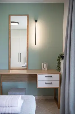 a bedroom with a dressing table with a mirror at Elysian Sea-View Chania in Stérnai