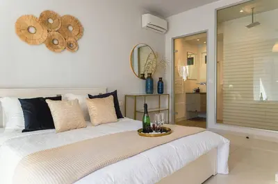 a bedroom with a large bed with a bottle of champagne at G&M Luxury Residence with pool in Chania Town