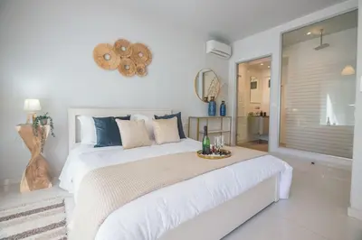 a bedroom with a large white bed with a tray on it at G&M Luxury Residence with pool in Chania Town