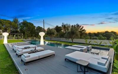 a pool with white lounge chairs and a swimming pool at Chania lux villa with Heated pool in Chania Town