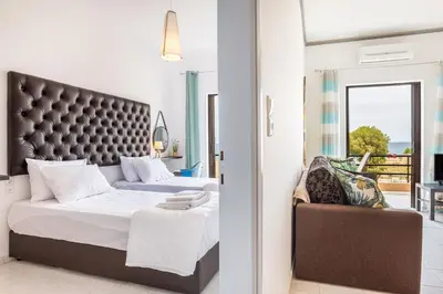a bedroom with a large bed and a chair at Sun Beach Apartments in Chania 8 &10& 13 in Chania Town