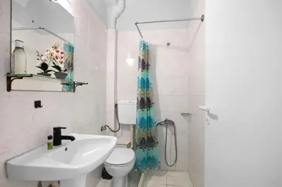 a white bathroom with a sink and a toilet at Sun Beach Apartments in Chania 8 &10& 13 in Chania Town