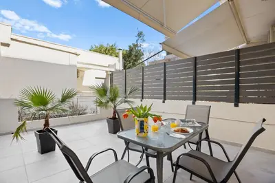 a patio with a table and chairs on a balcony at Apartment Arancione in Chania Town