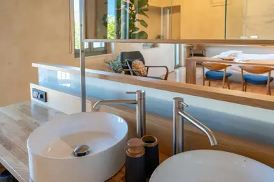 a bathroom with a sink and a toilet on a counter at Kallergon Luxury Suites in Chania Town