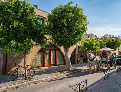 a horse drawn carriage on a city street at Kallergon Luxury Suites in Chania Town