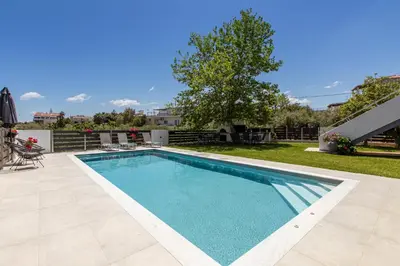 a swimming pool in the backyard of a house at Crystal Waves lux villa-Homeleader in Chania Town