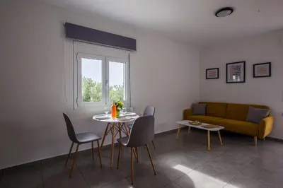 a living room with a table and a couch at heaven suite elafonisi in Elafonisi