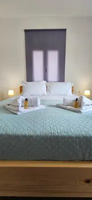 a bedroom with two beds with towels on them at heaven suite elafonisi in Elafonisi
