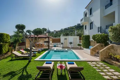 a backyard with a swimming pool and a villa at Villa Georgia Heated Pool & Jet-Tub in Kolymvari