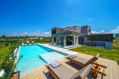 a villa with a swimming pool and a house at ISKIOS Premium in Agia Marina Nea Kydonias