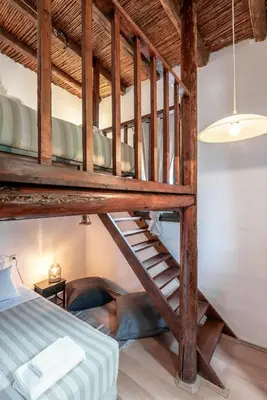 a loft bed with a ladder in a room at Joel Living Collection - Rustic Villa in Áptera