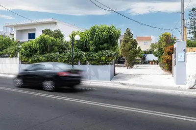 a black car driving down a city street at ''Meraviglia'' casa ''Nefeli'' in Chania Town