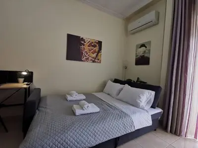 a bedroom with a bed with towels on it at Comfy APT in Chania City Center in Chania Town