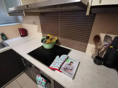 a kitchen with a sink and a book on the counter at Comfy APT in Chania City Center in Chania Town