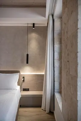 a bedroom with a white bed and a curtain at Casa Dorini in Chania Town