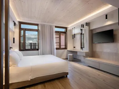 a bedroom with a bed and a flat screen tv at Casa Dorini in Chania Town