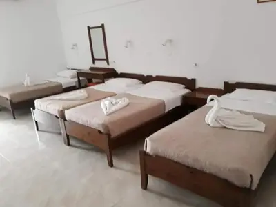 a room with four beds with a swan on them at Studios Stavris in Frangokastello