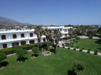 an aerial view of a large white building with palm trees at Studios Stavris in Frangokastello