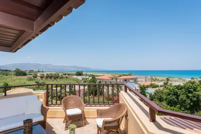 a balcony with chairs and a view of the ocean at Iason Villas – Chania, Crete in Maleme