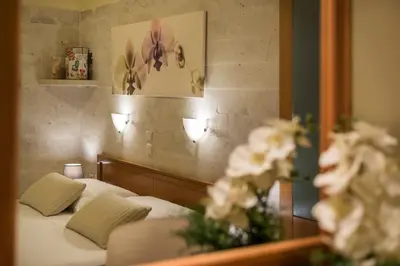 a bedroom with a bed in front of a mirror at Iason Villas – Chania, Crete in Maleme