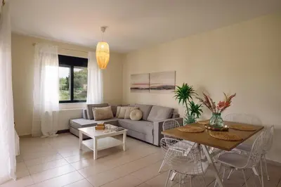 a living room with a couch and a table at Helen Sweet Home in Kounoupidhianá