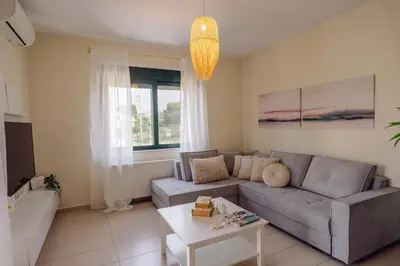 a living room with a couch and a table at Helen Sweet Home in Kounoupidhianá