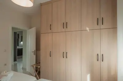 a room with wooden cabinets in a bedroom at Helen Sweet Home in Kounoupidhianá