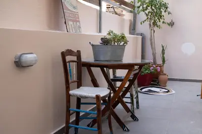 a small table with a potted plant on top of it at Cactus Residence Chania in Chania Town