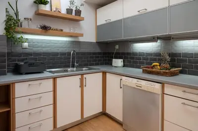 a kitchen with white cabinets and a sink at Cactus Residence Chania in Chania Town