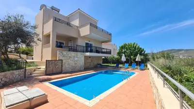 a villa with a swimming pool in front of a house at VILLA PAGONI Residence Selini Villas N 1 Kolymbari Chania in Kolymvari