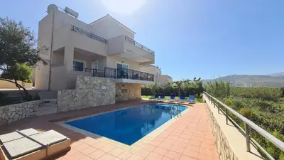 a villa with a swimming pool in front of a house at VILLA PAGONI Residence Selini Villas N 1 Kolymbari Chania in Kolymvari