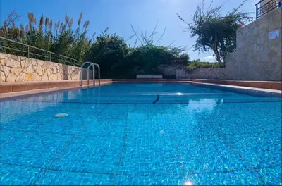 a large swimming pool with blue water at VILLA PAGONI Residence Selini Villas N 1 Kolymbari Chania in Kolymvari