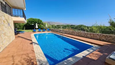 a swimming pool next to a house at VILLA PAGONI Residence Selini Villas N 1 Kolymbari Chania in Kolymvari