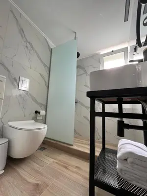 a bathroom with a white toilet and a sink at Anna's Apartment in Kato Daratso