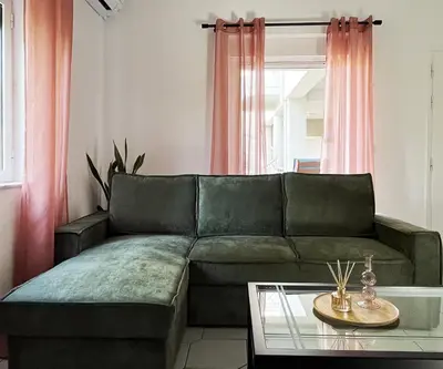 a living room with a couch and a table at Anna's Apartment in Kato Daratso