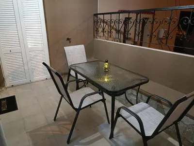 a black table and chairs with a bottle on it at Vrachakia Stylish in Ayiá
